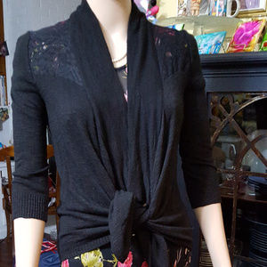 Ladies. Front tie 3/4 sleeves,black sweater.(M)  "Lace" across shoulders.